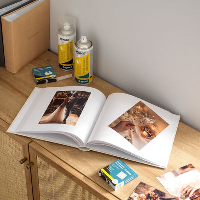 Open wedding photo album on table with Kenair adhesives