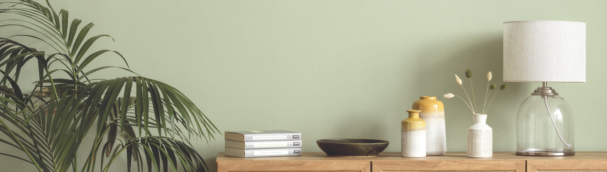 sideboard with Kenro vases against green wall
